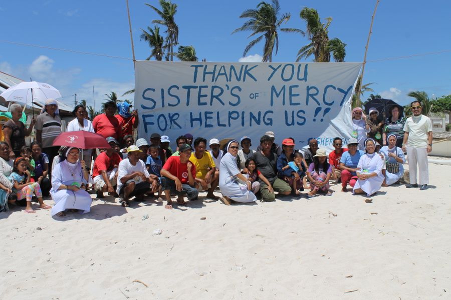 Philippine Mercies and locals thanking MIA for financial support in wake of Typhoon Yolanda, 2013